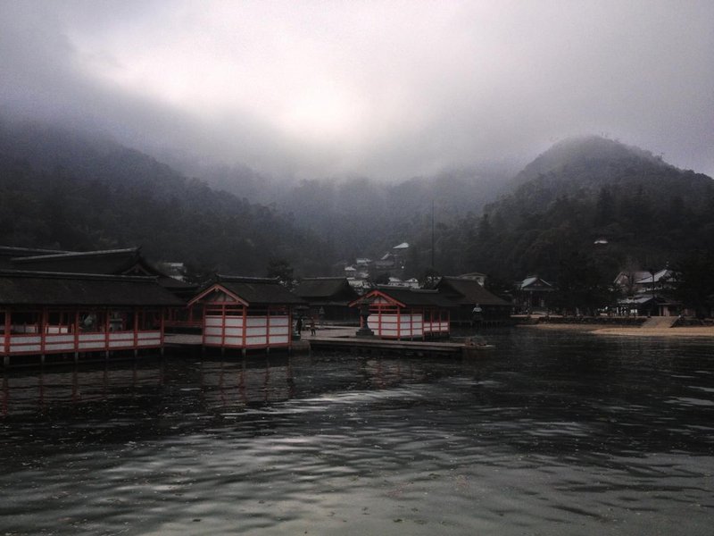 Foggy landscape with oily sea in the foreground, japanese pier and houses in the middle, and foggy tree-covered hills in the background.jpg